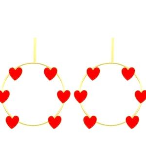 Gold hoop earrings with red hearts.